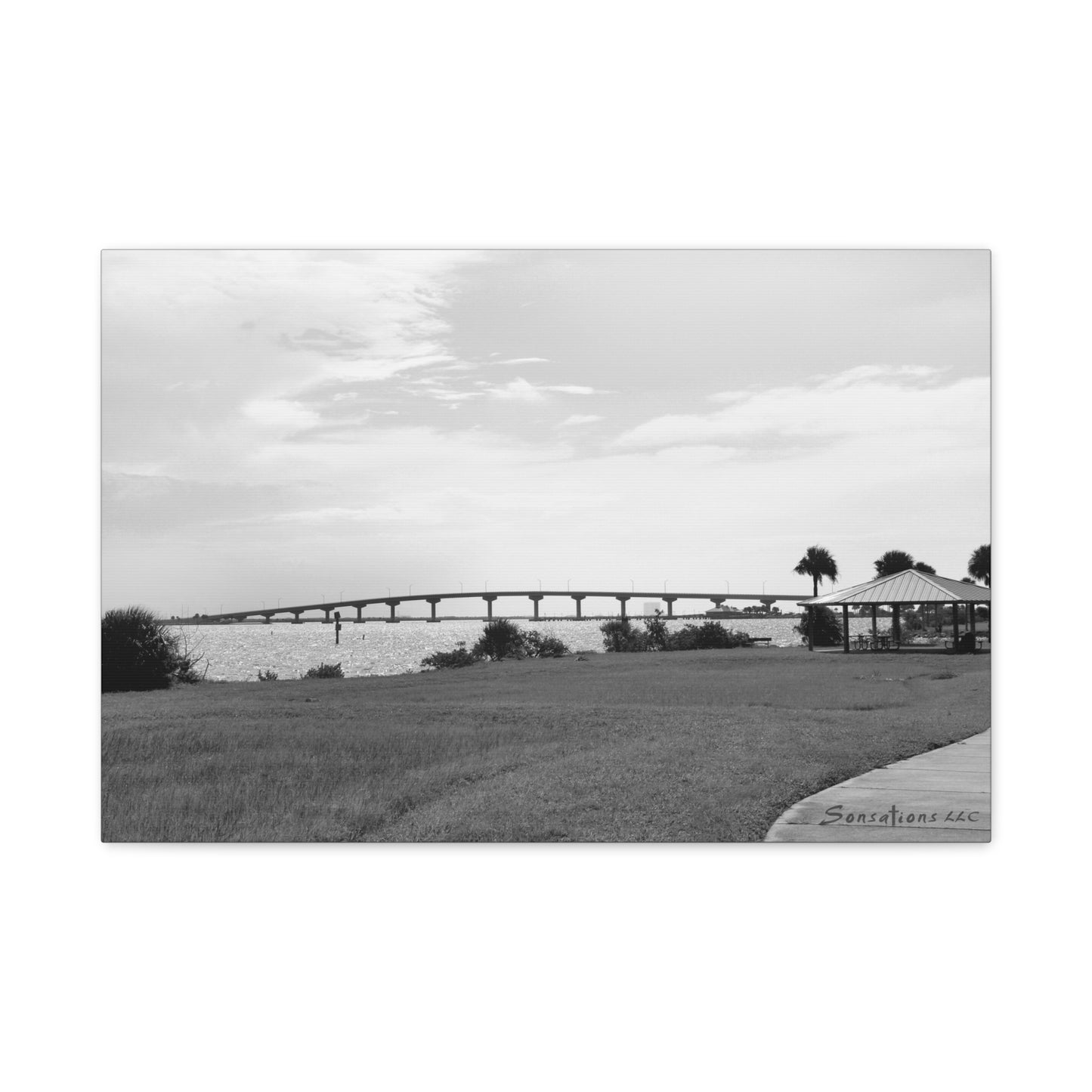 Black and white modern bridge canvas art featuring a scenic bridge over water with grassy foreground