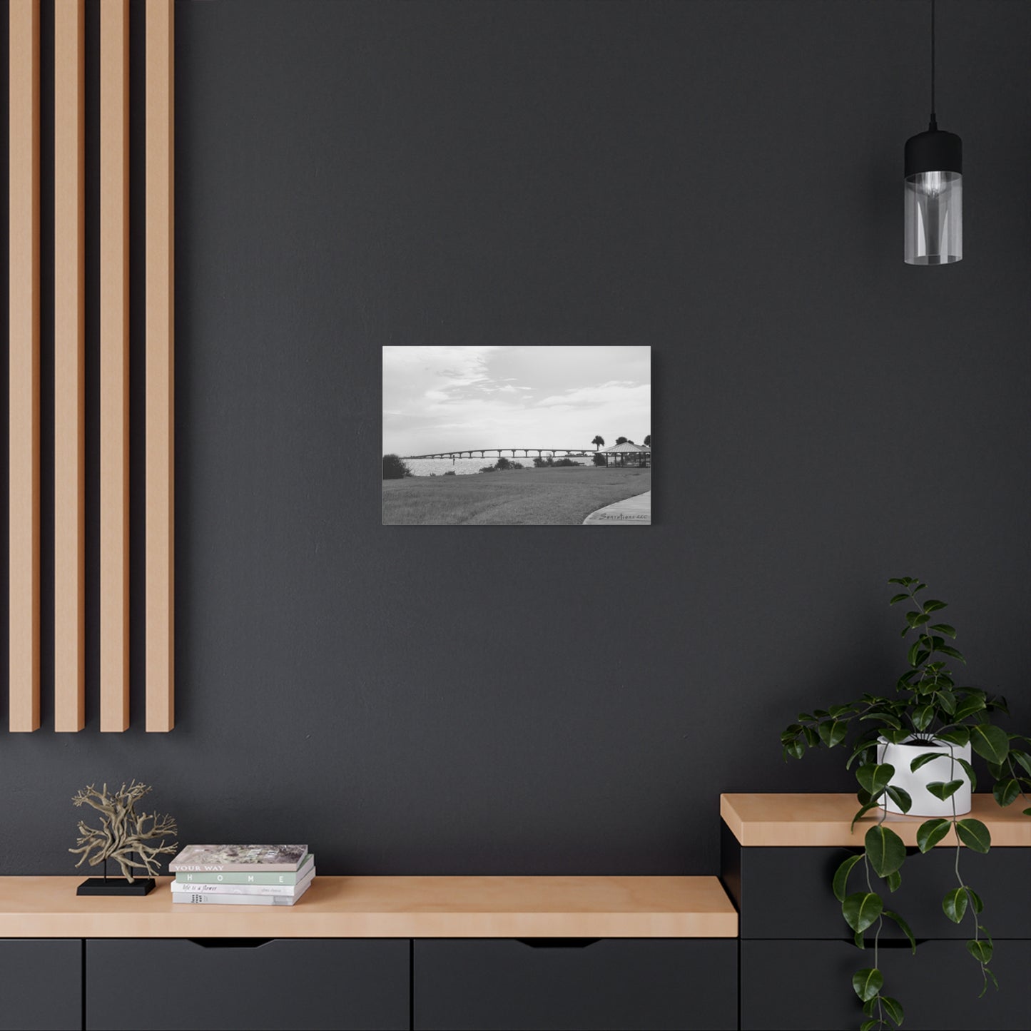 Black and white modern bridge canvas art displayed on a sleek wall shelf in a stylish interior