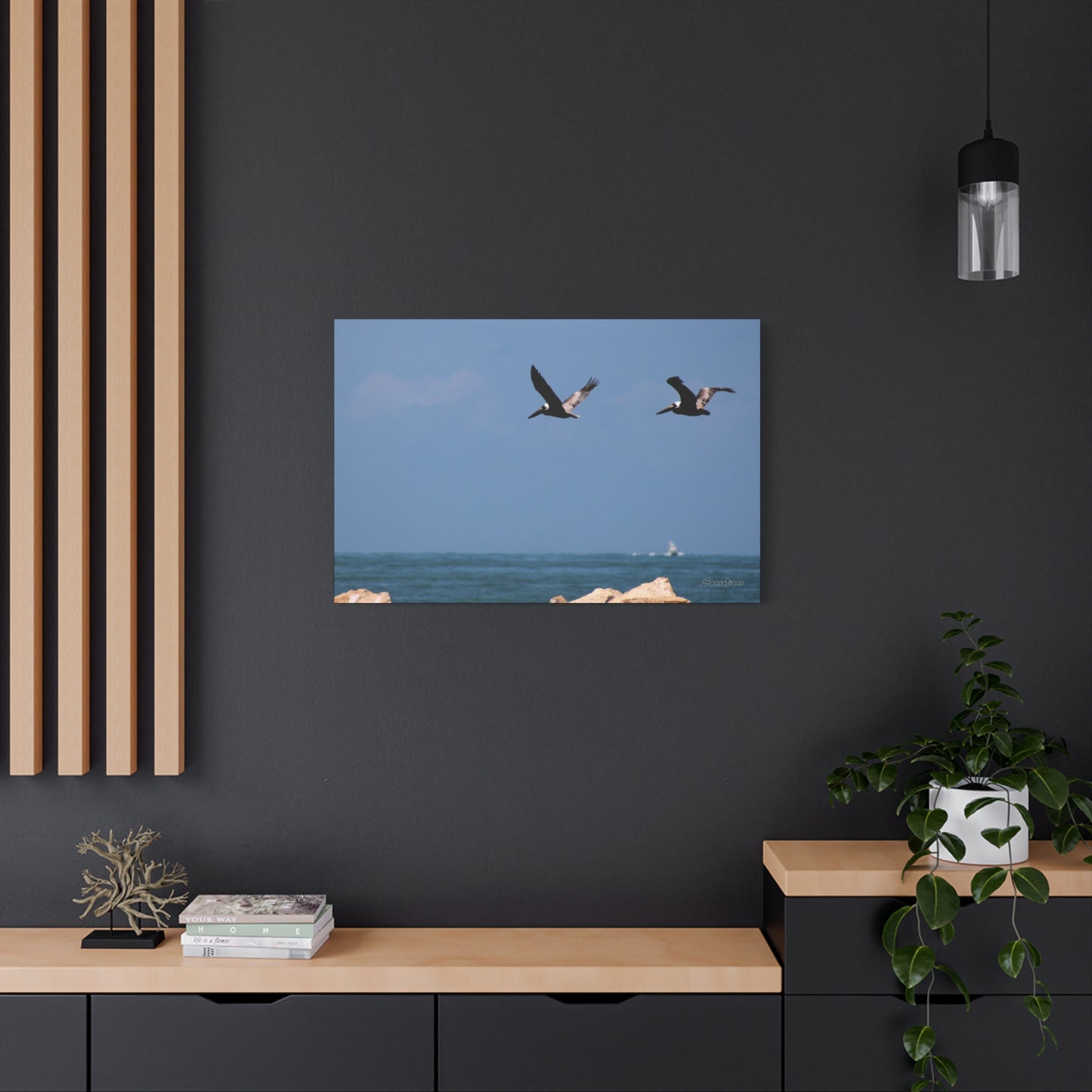 Coastal bird wall art featuring two birds flying over the ocean against a tranquil blue sky