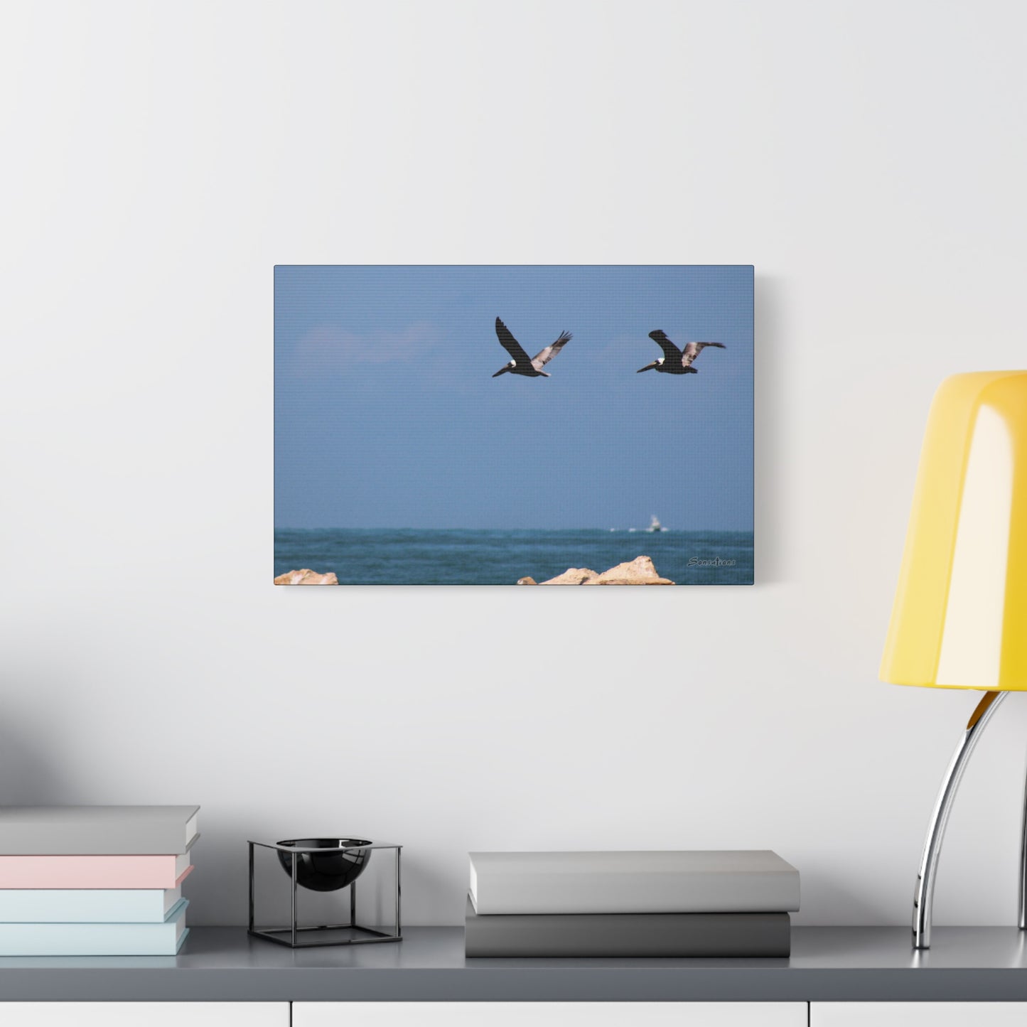 Coastal bird wall art featuring two birds flying over the ocean on a canvas print