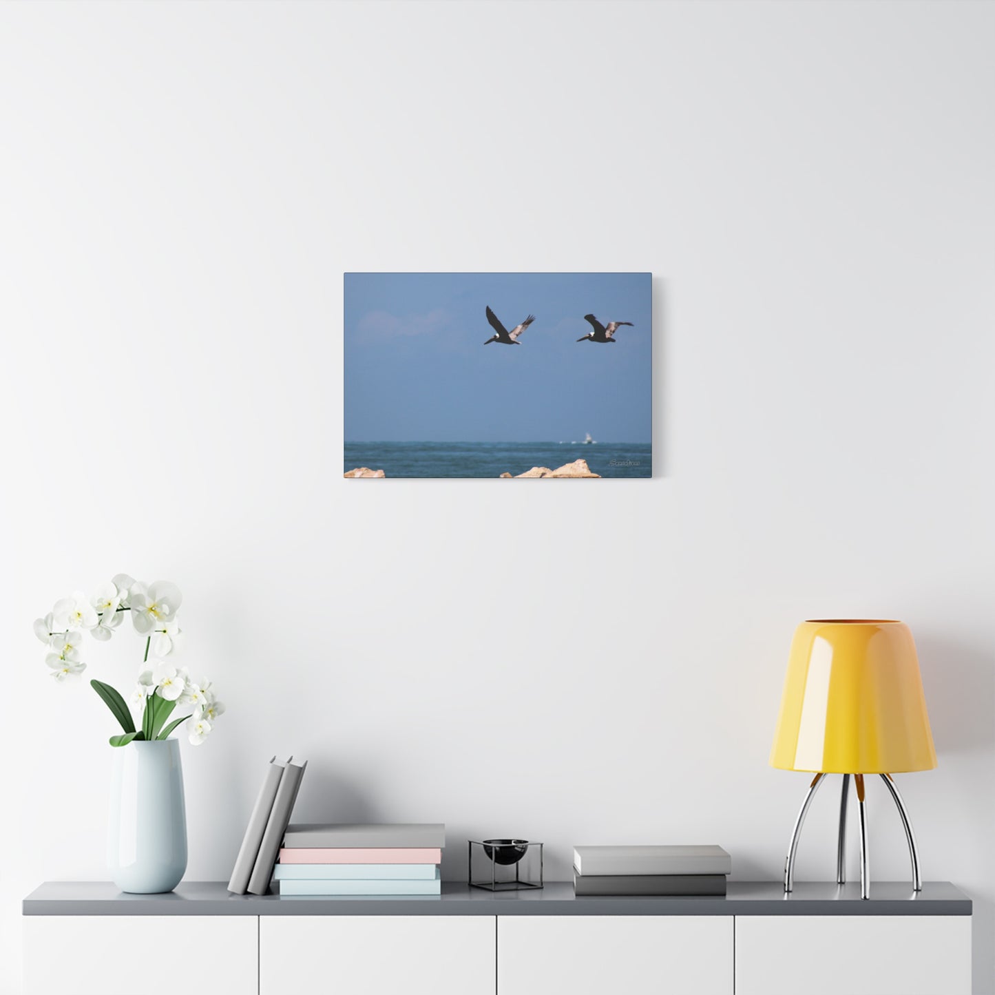 Coastal bird wall art featuring two birds flying over a serene ocean landscape