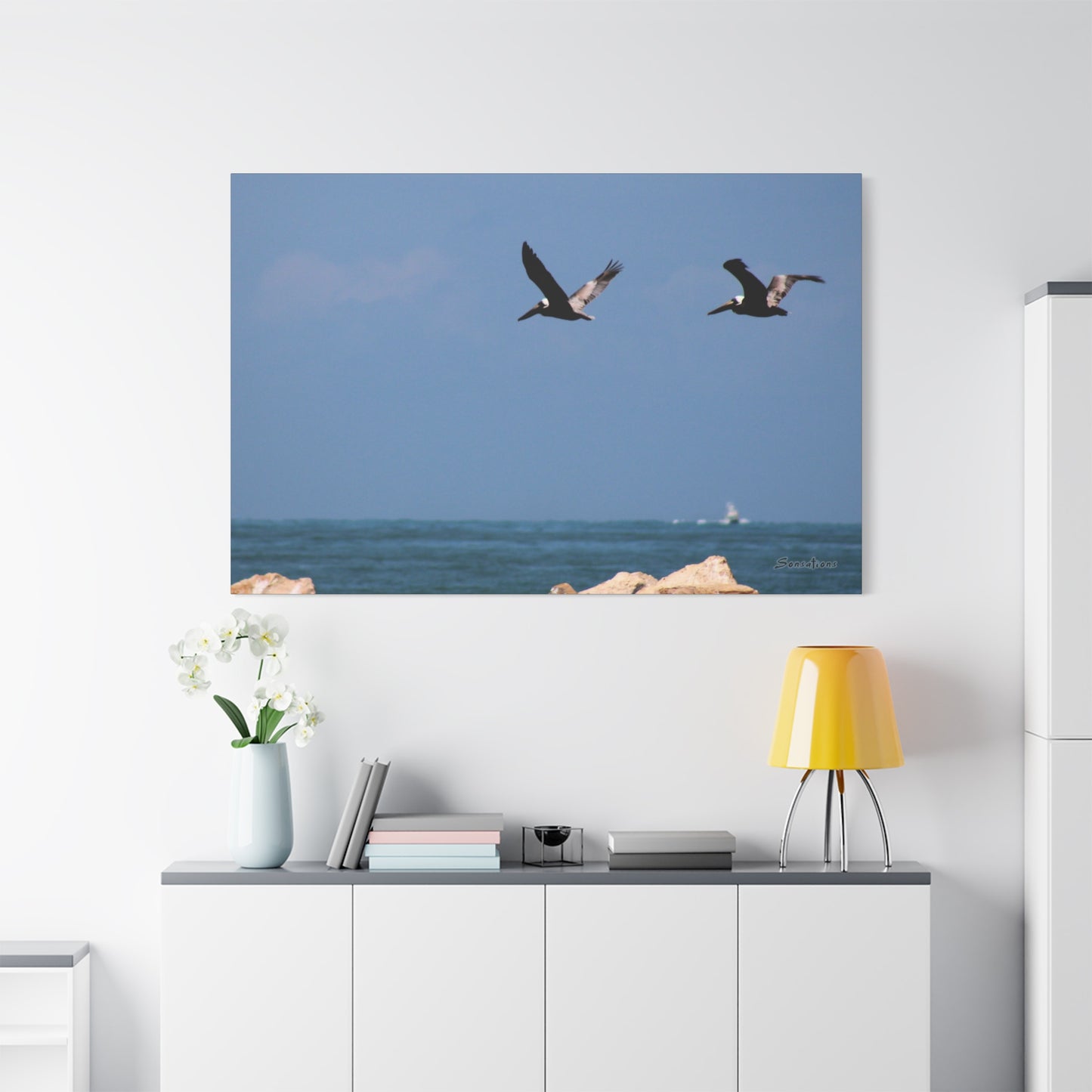 Coastal bird wall art featuring two birds in flight over a tranquil ocean backdrop