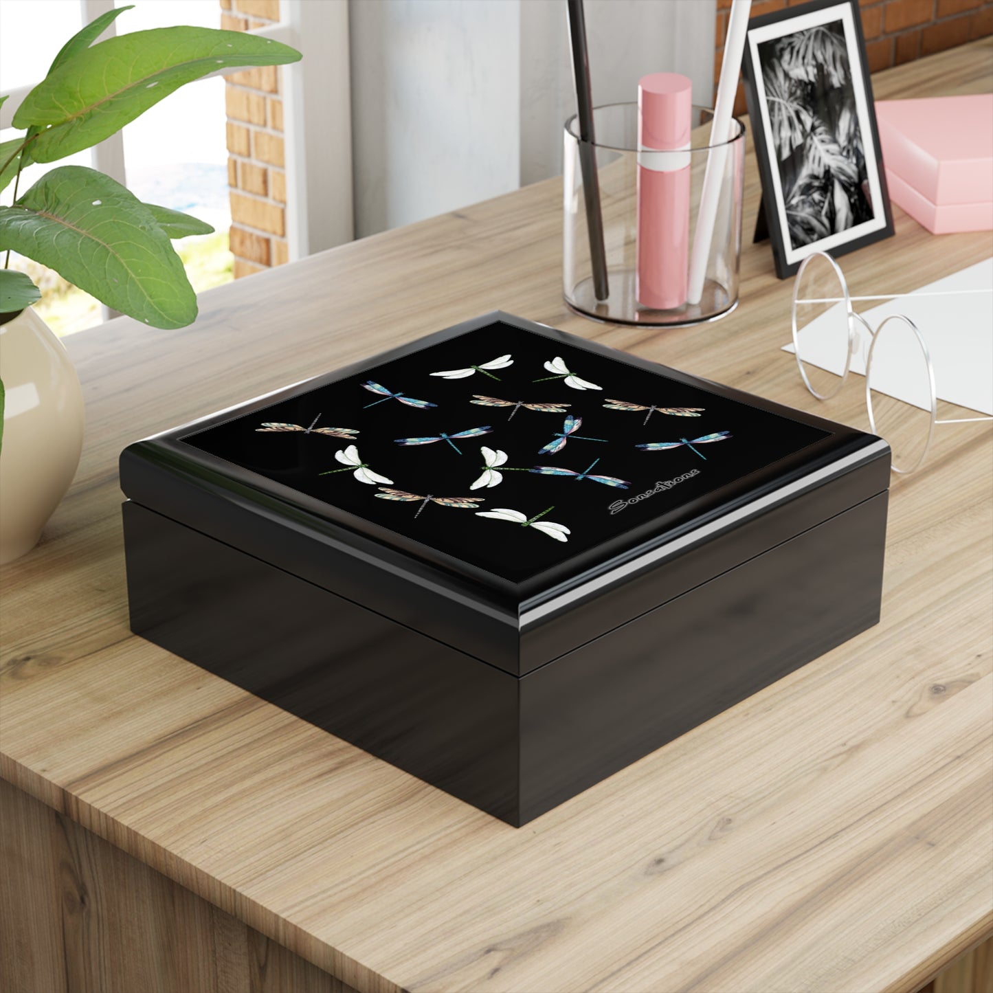 Elegant dragonfly jewelry box with intricate design, perfect for storing accessories on a desk
