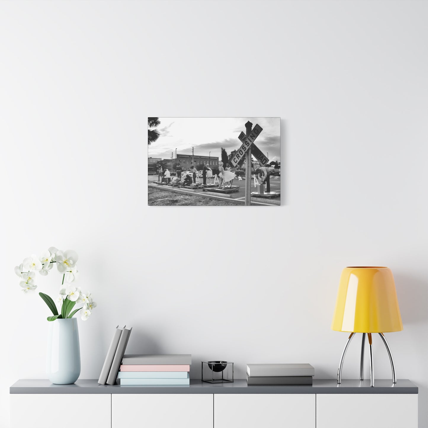 Stylish Marilyn Monroe canvas art displayed above a modern decor featuring a vase and lamp
