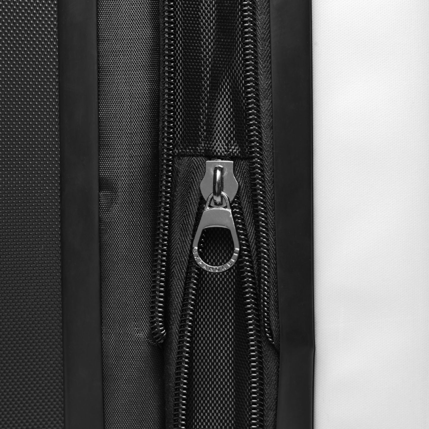 Close-up of a black zipper on a retro postcard luggage bag with durable fabric construction
