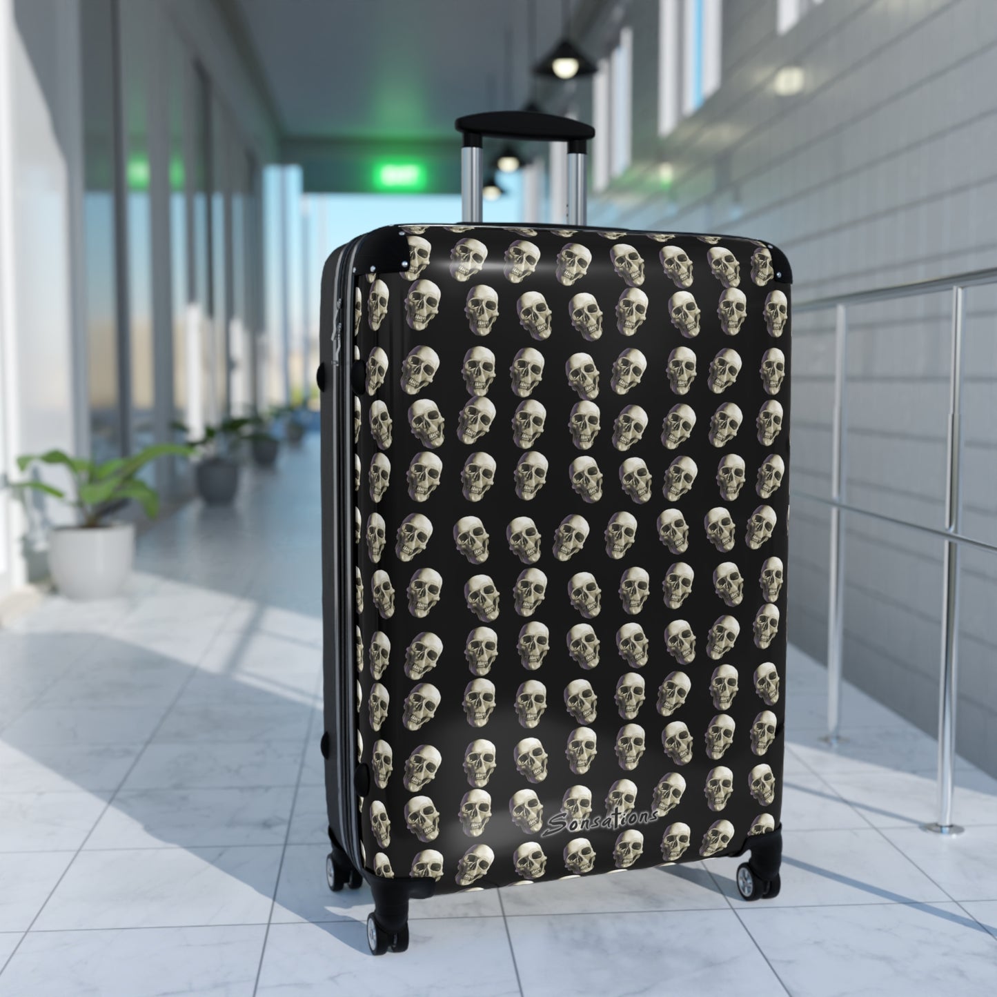 Skull print suitcase featuring a stylish design with multiple skulls on a black background