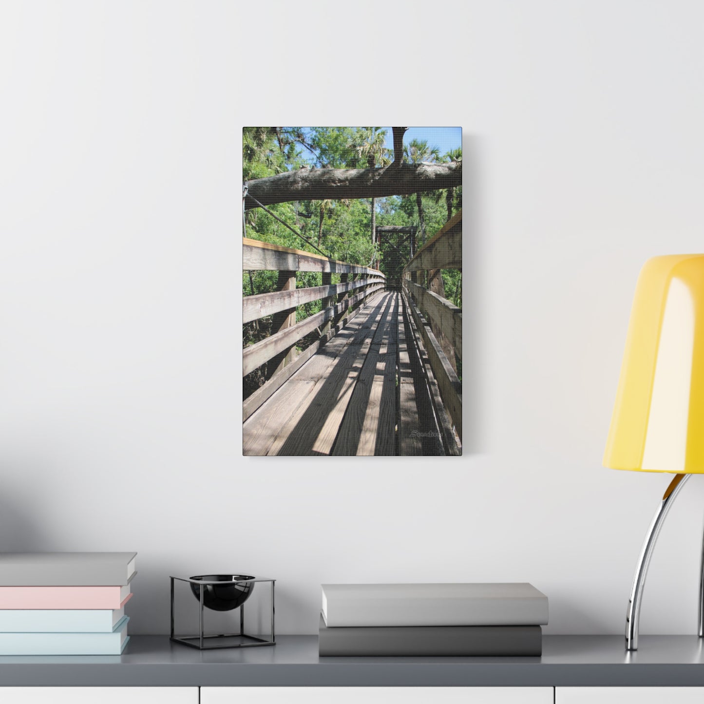 Tranquil bridge nature wall art showcasing a wooden bridge surrounded by lush greenery