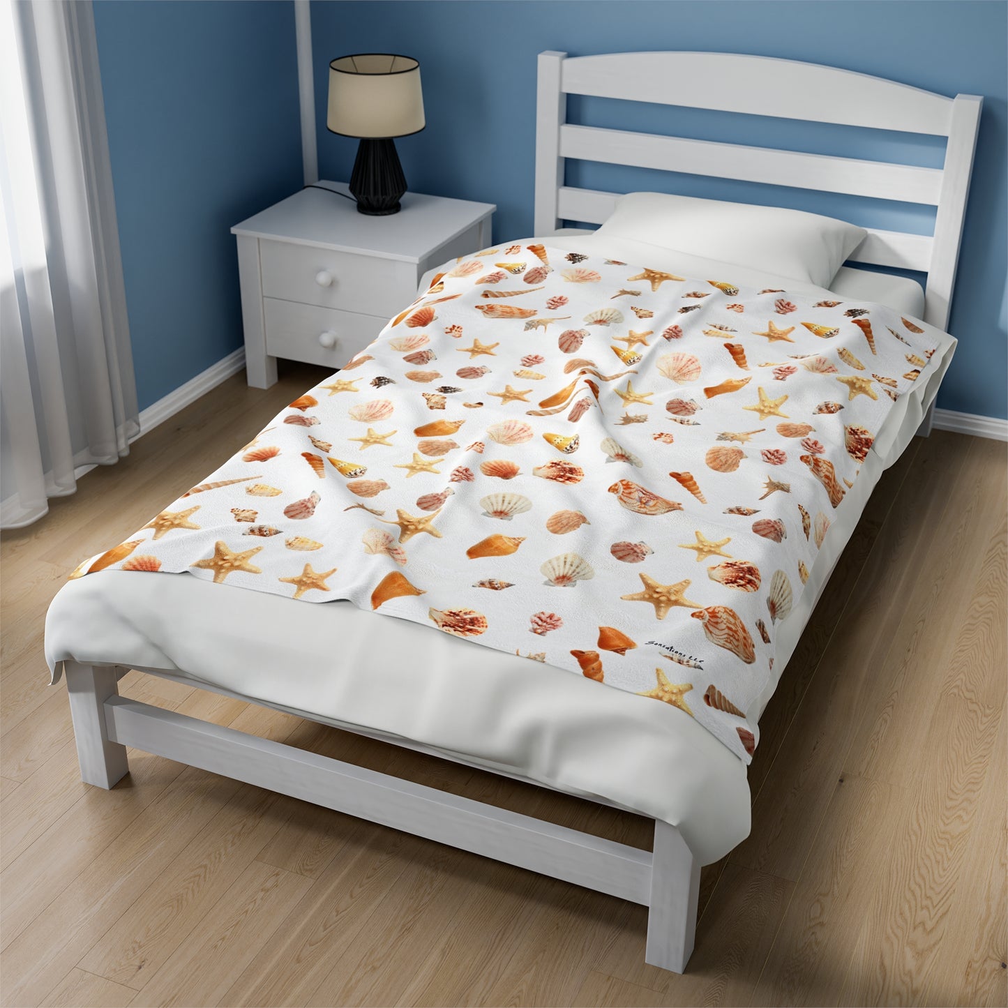 Sea shell velveteen blanket featuring colorful shells and starfish on a white background for cozy bedding
