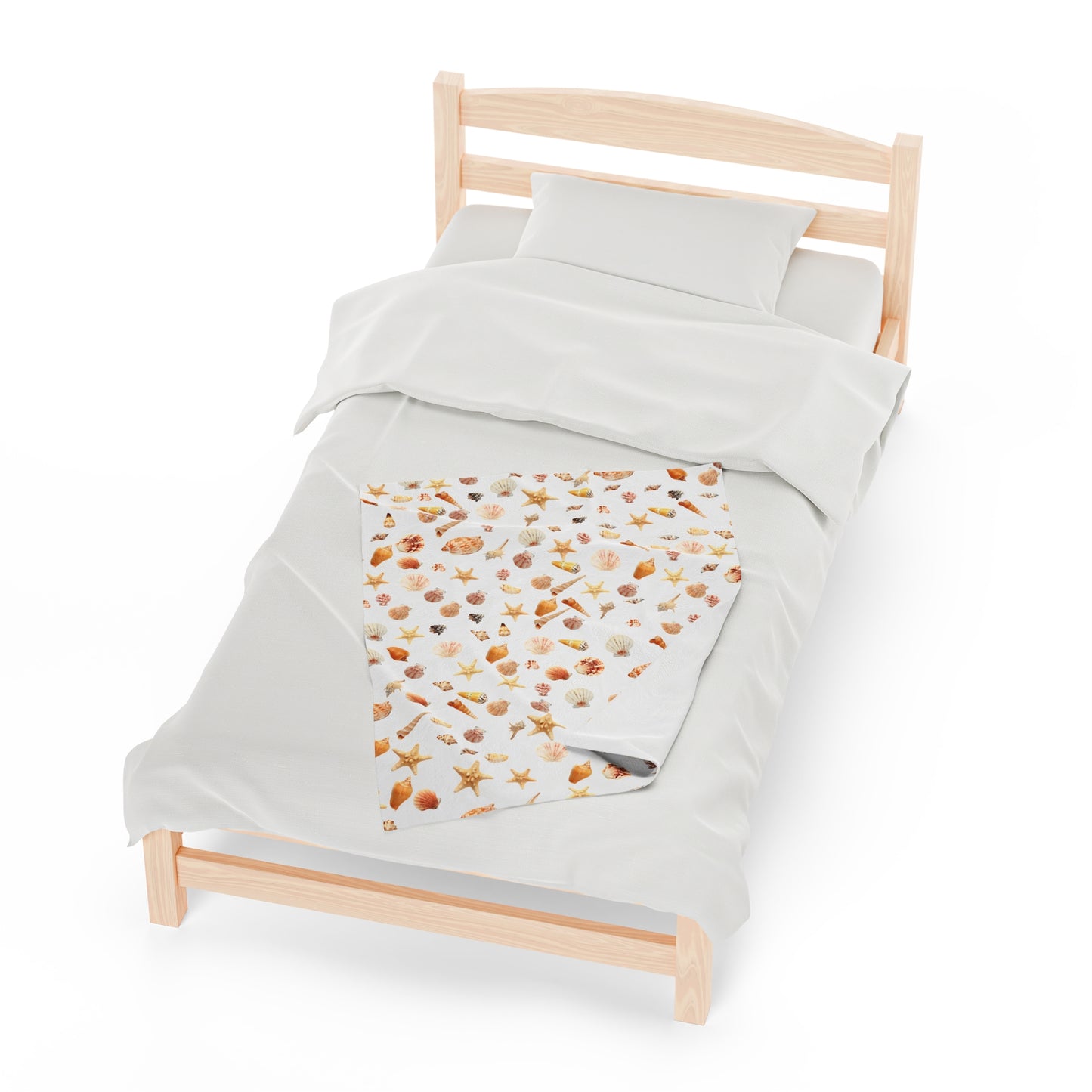 Sea shell velveteen blanket featuring a vibrant print of seashells on a light background