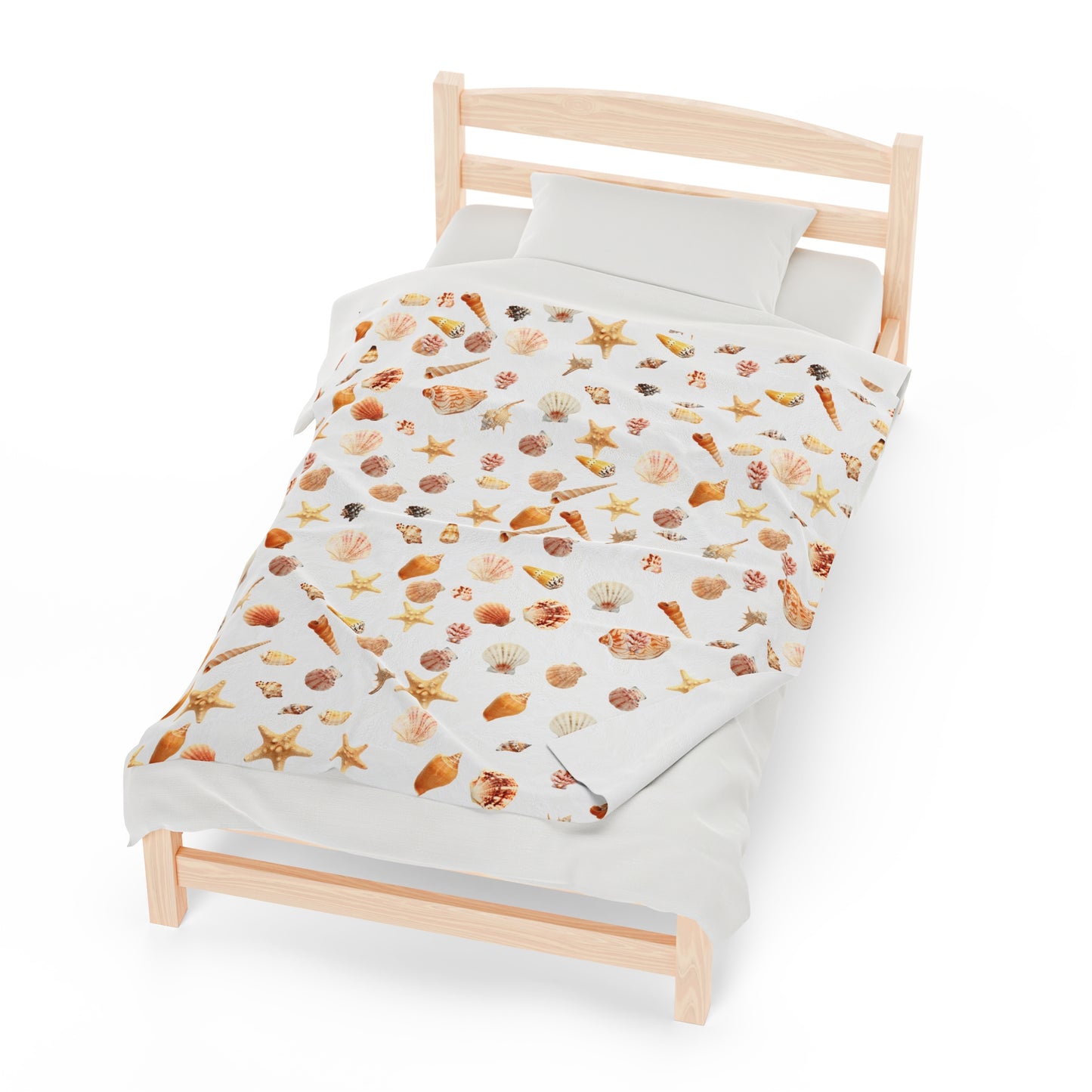 Cozy sea shell velveteen blanket featuring a colorful shell pattern on a bed