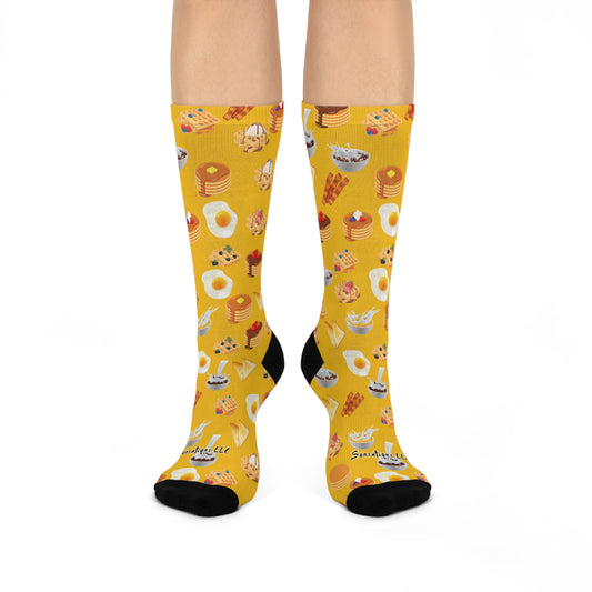 Bright yellow breakfast-themed socks featuring colorful illustrations of food items like pancakes and eggs