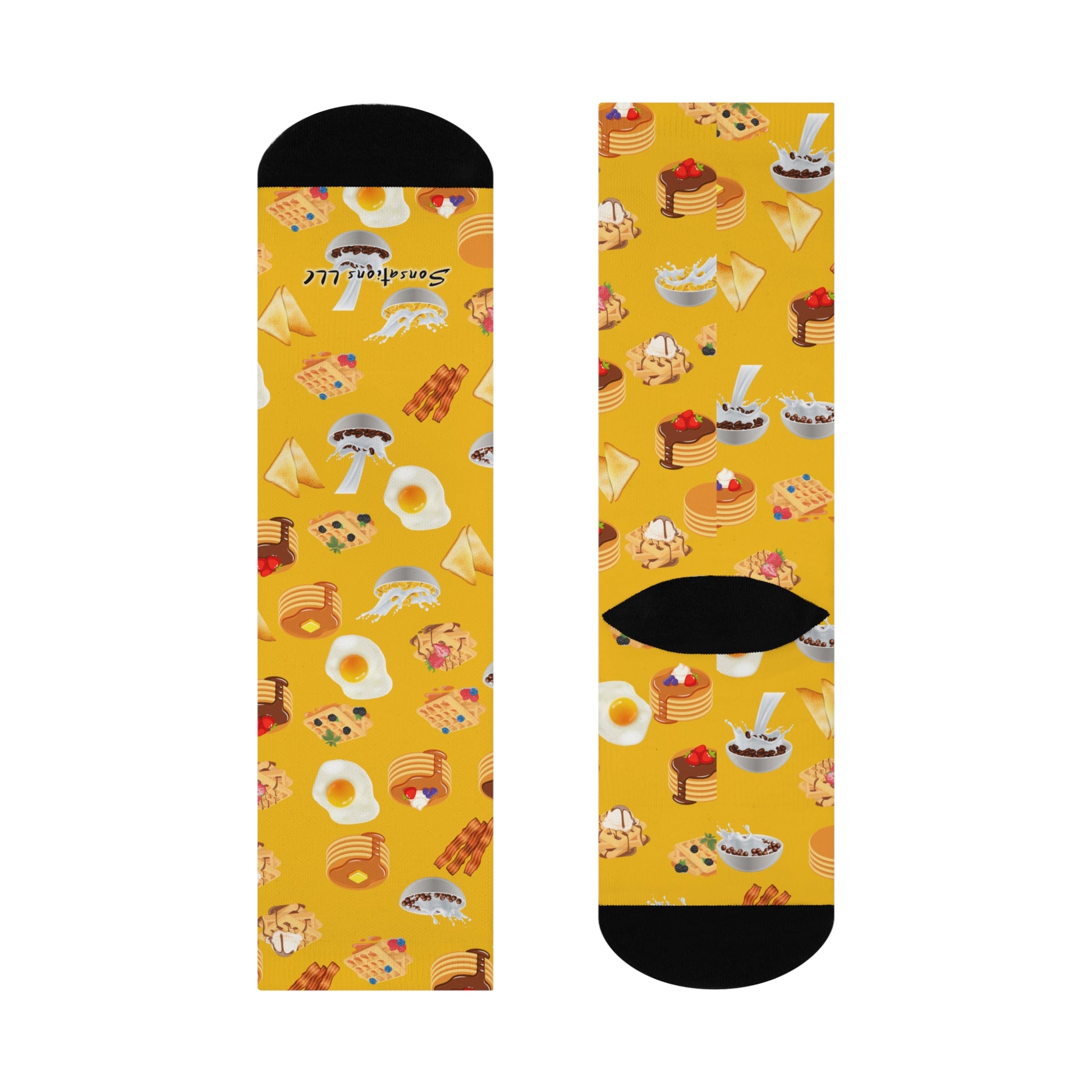 Colorful breakfast-themed socks featuring pancakes, eggs, and pastries on a yellow background