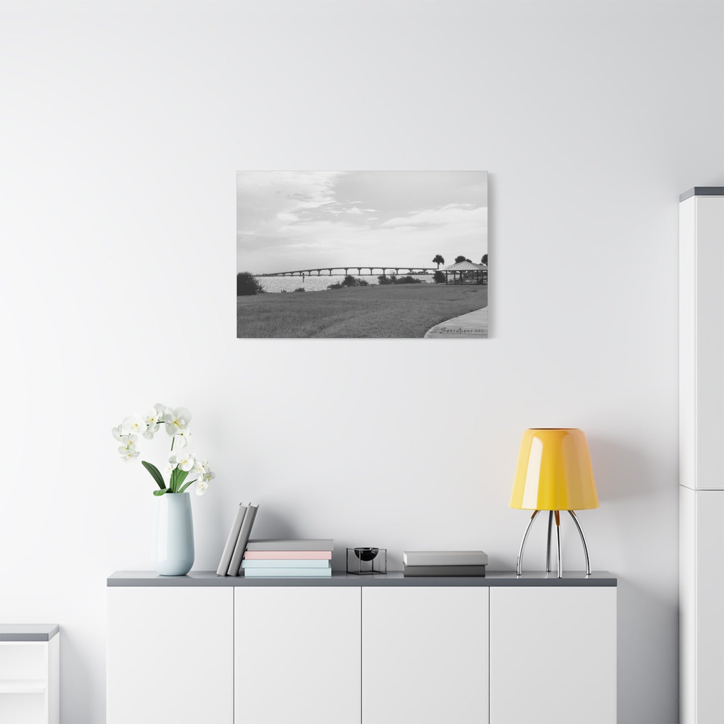 Elegant modern bridge canvas art in black and white displayed in a modern living room setting