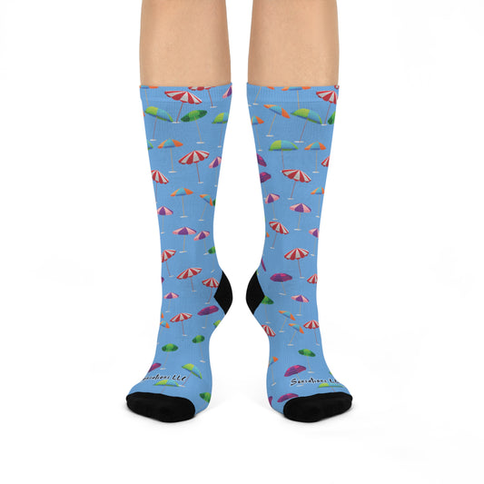 Crazy umbrella socks for sale with colorful umbrellas and bright design on a blue background
