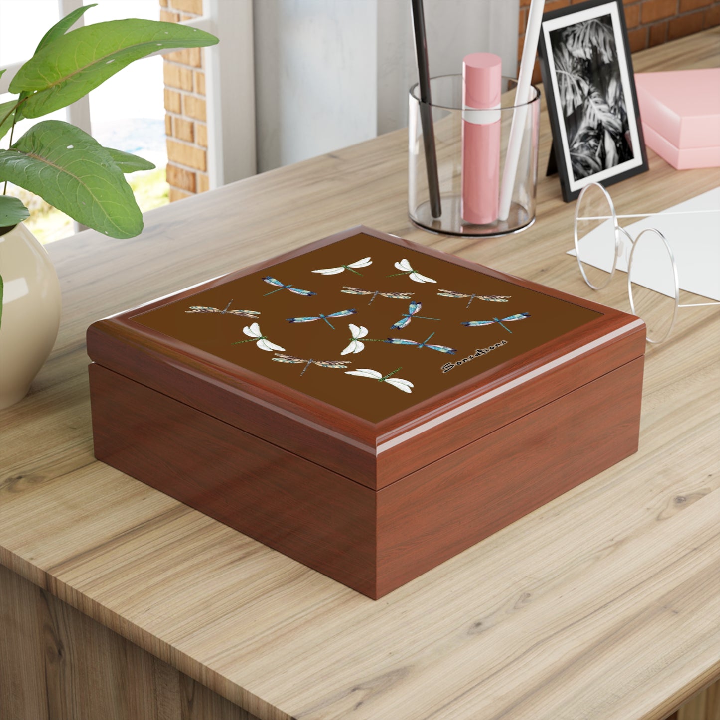 Elegant dragonfly jewelry box with a floral design, perfect for storing accessories on a desk