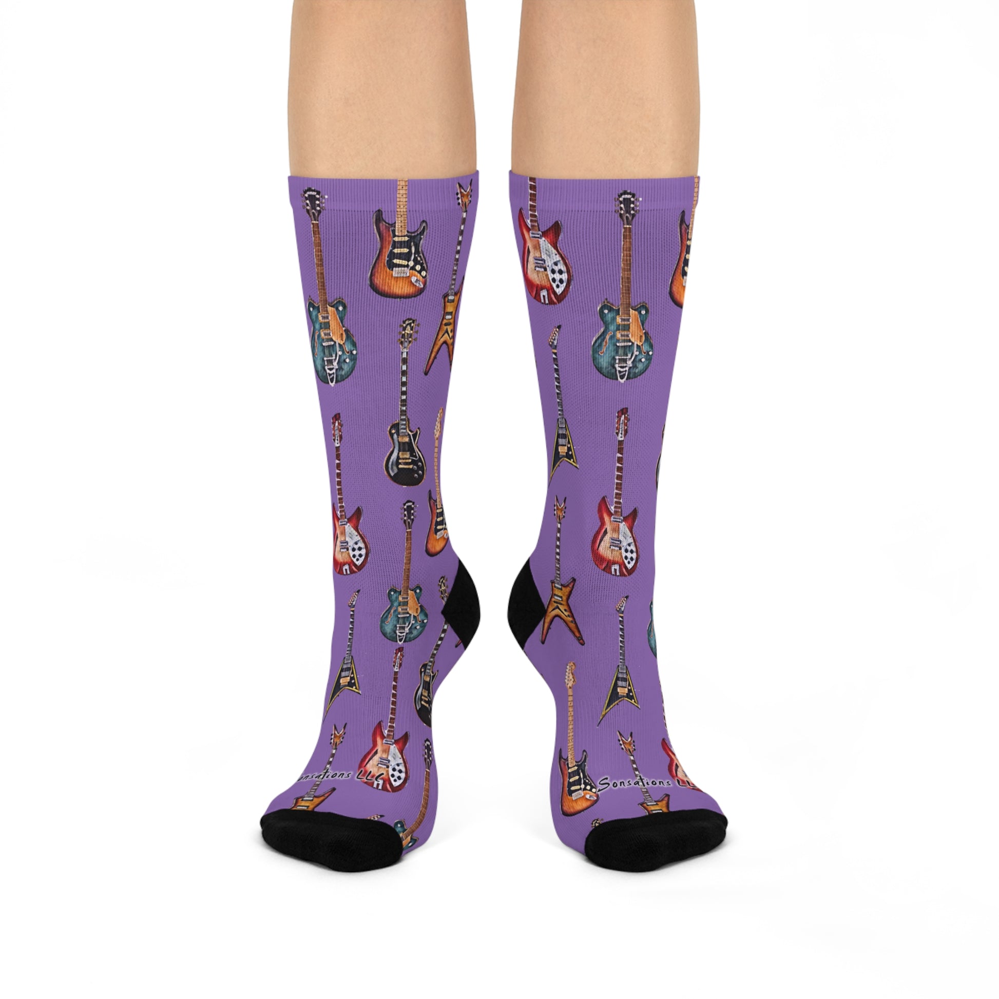 Guitar themed socks featuring colorful guitar prints on a stylish purple background