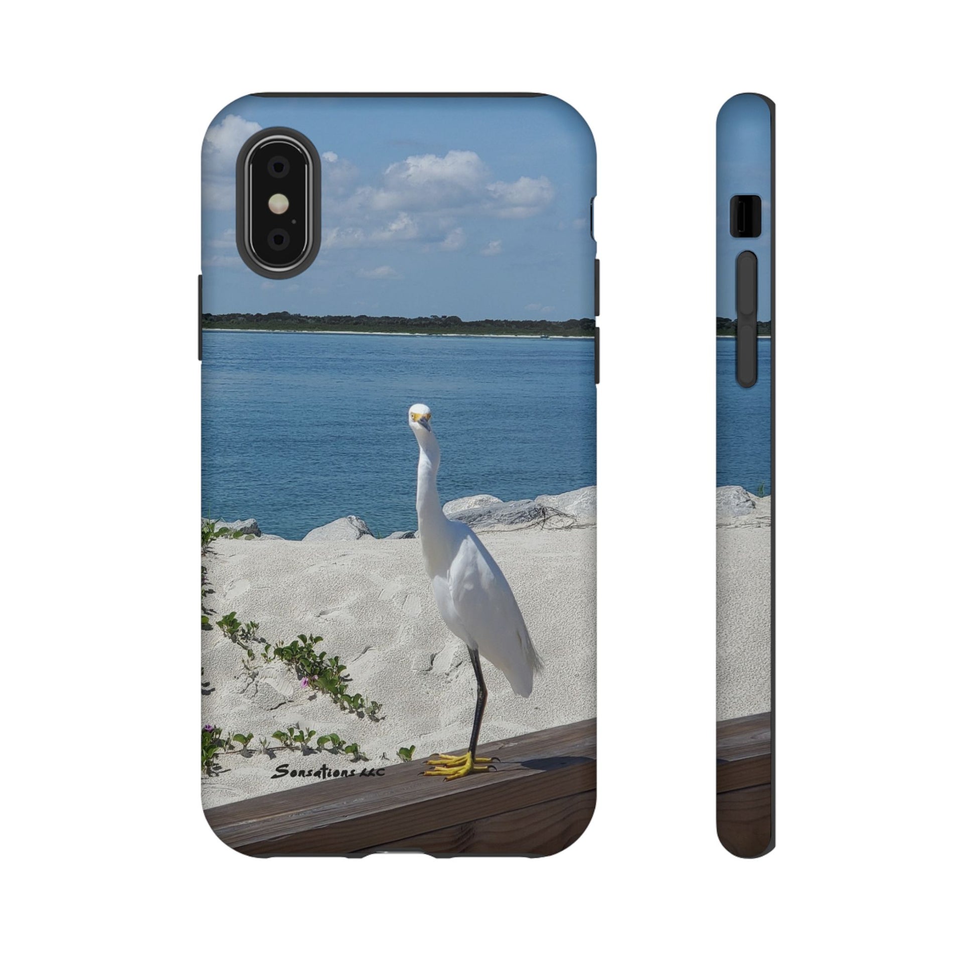White bird phone case featuring a heron standing near a serene beach backdrop