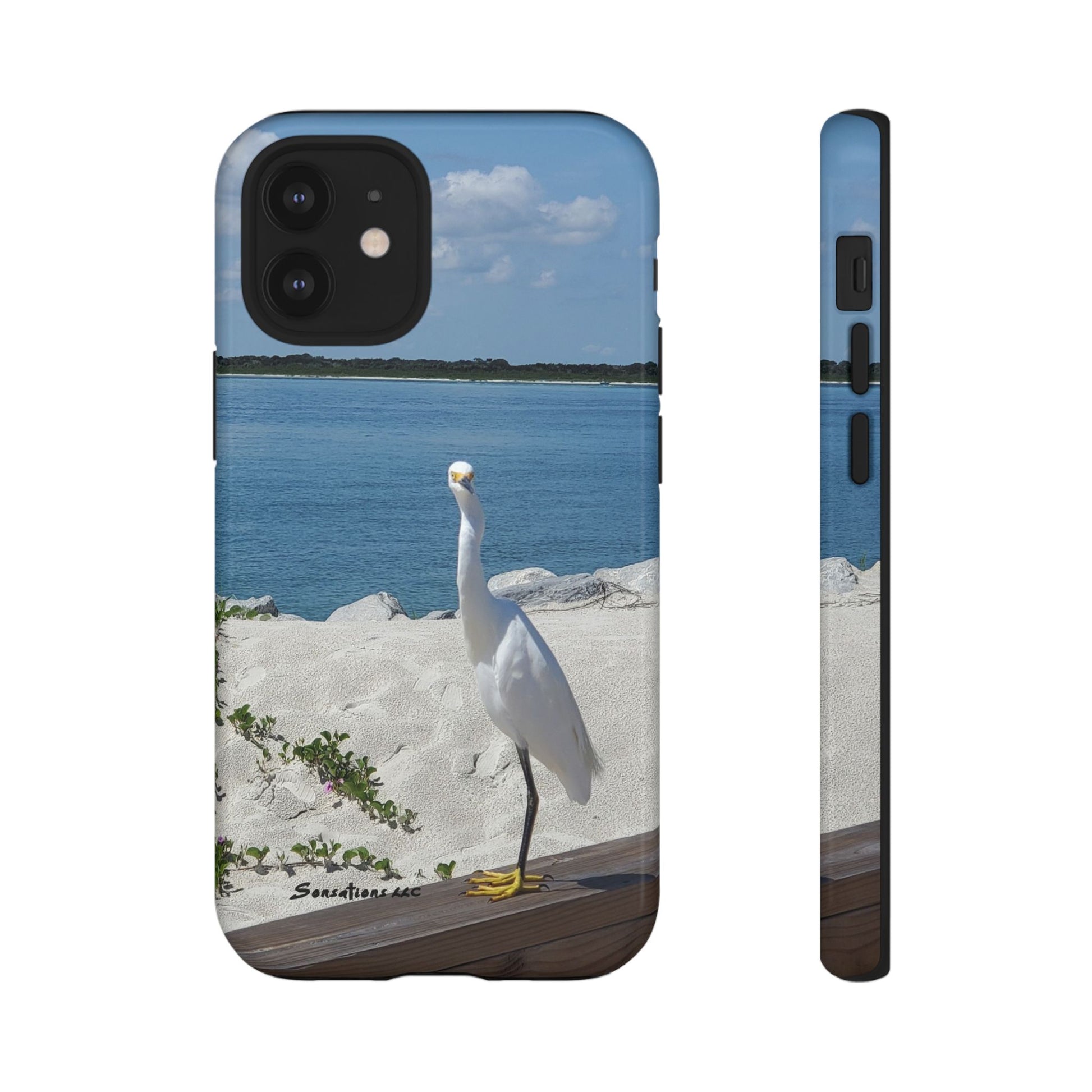 White bird phone case featuring a serene coastal scene with a heron near the water
