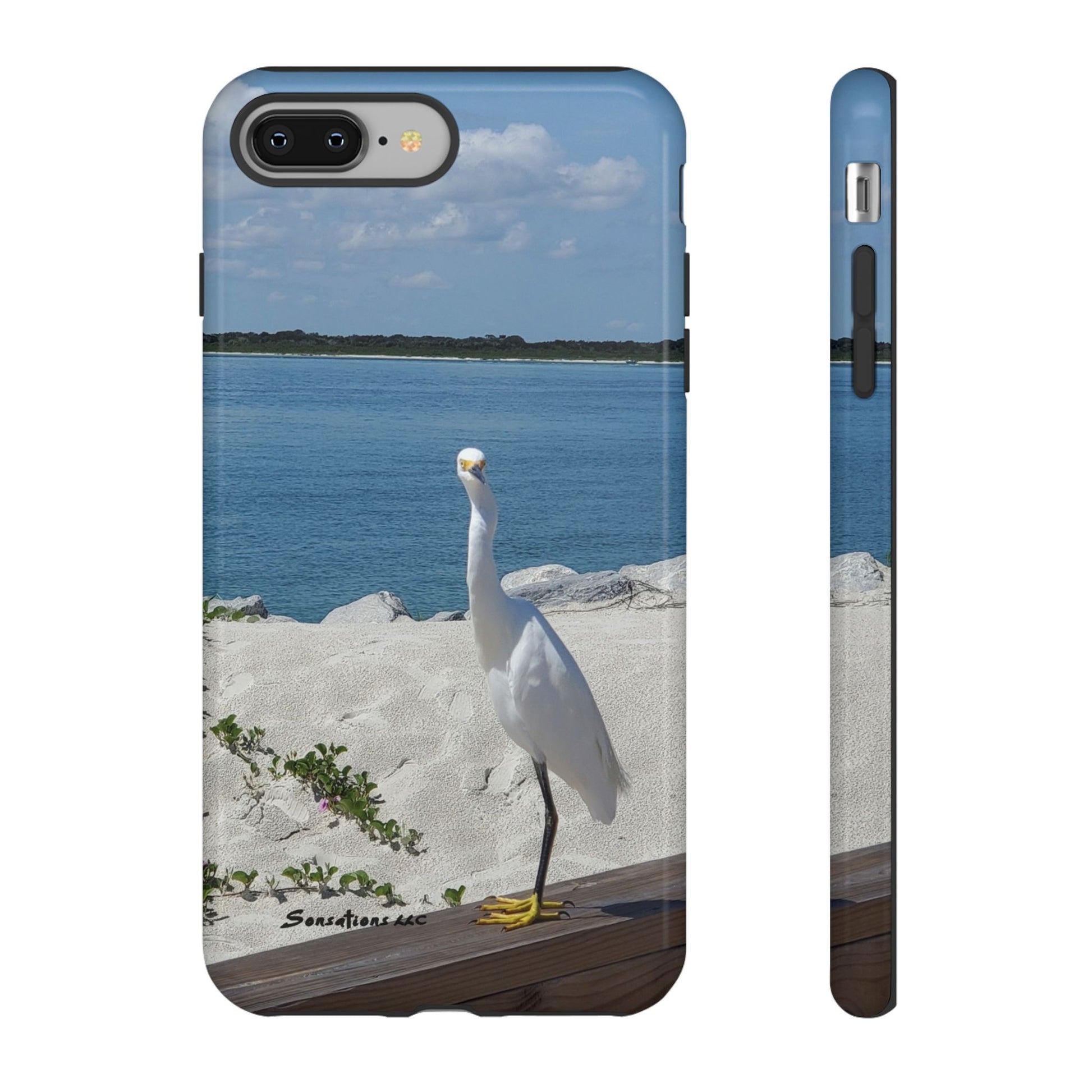 White bird phone case featuring a serene beach scene with an elegant bird by the water