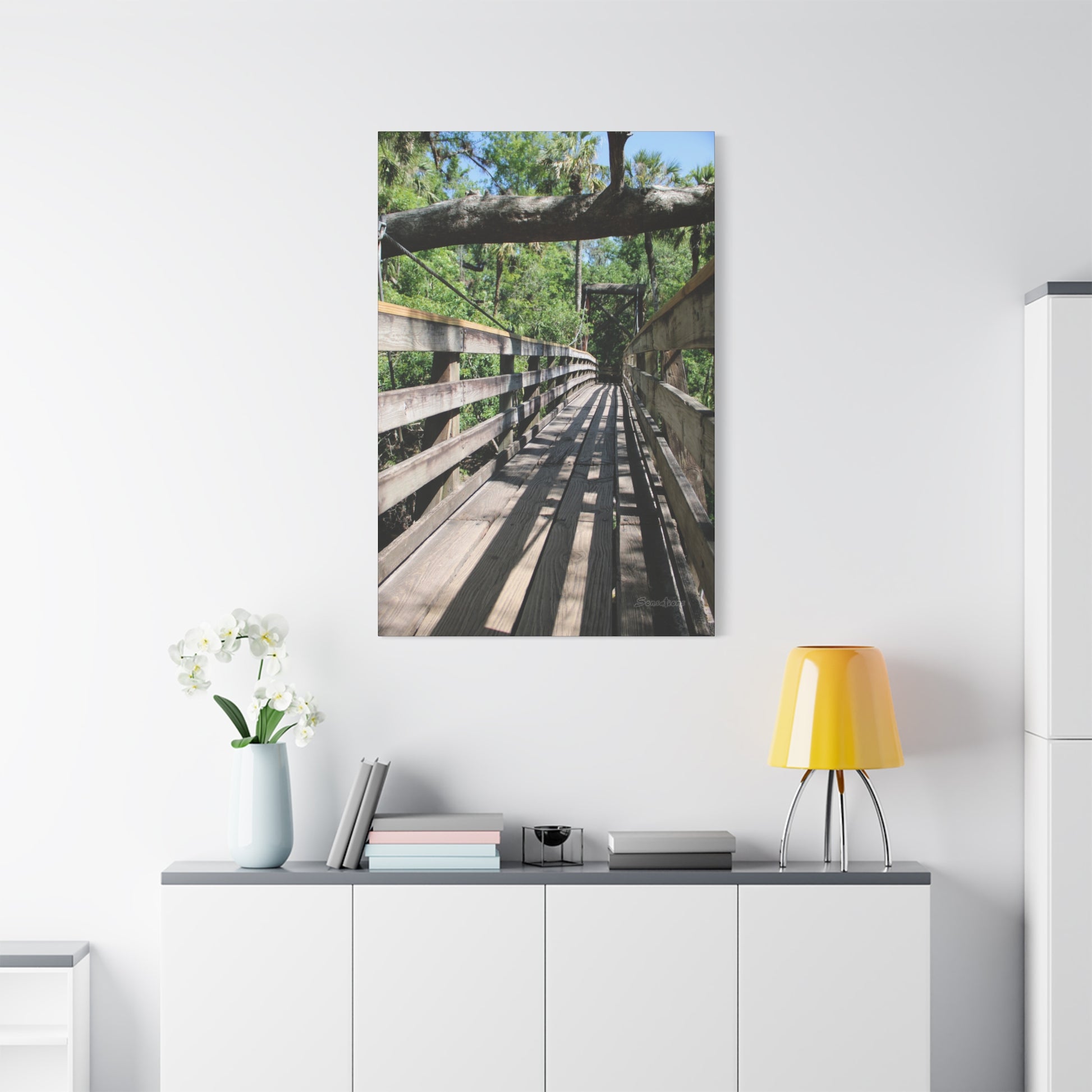 Tranquil bridge nature wall art depicting a serene wooden pathway surrounded by lush greenery