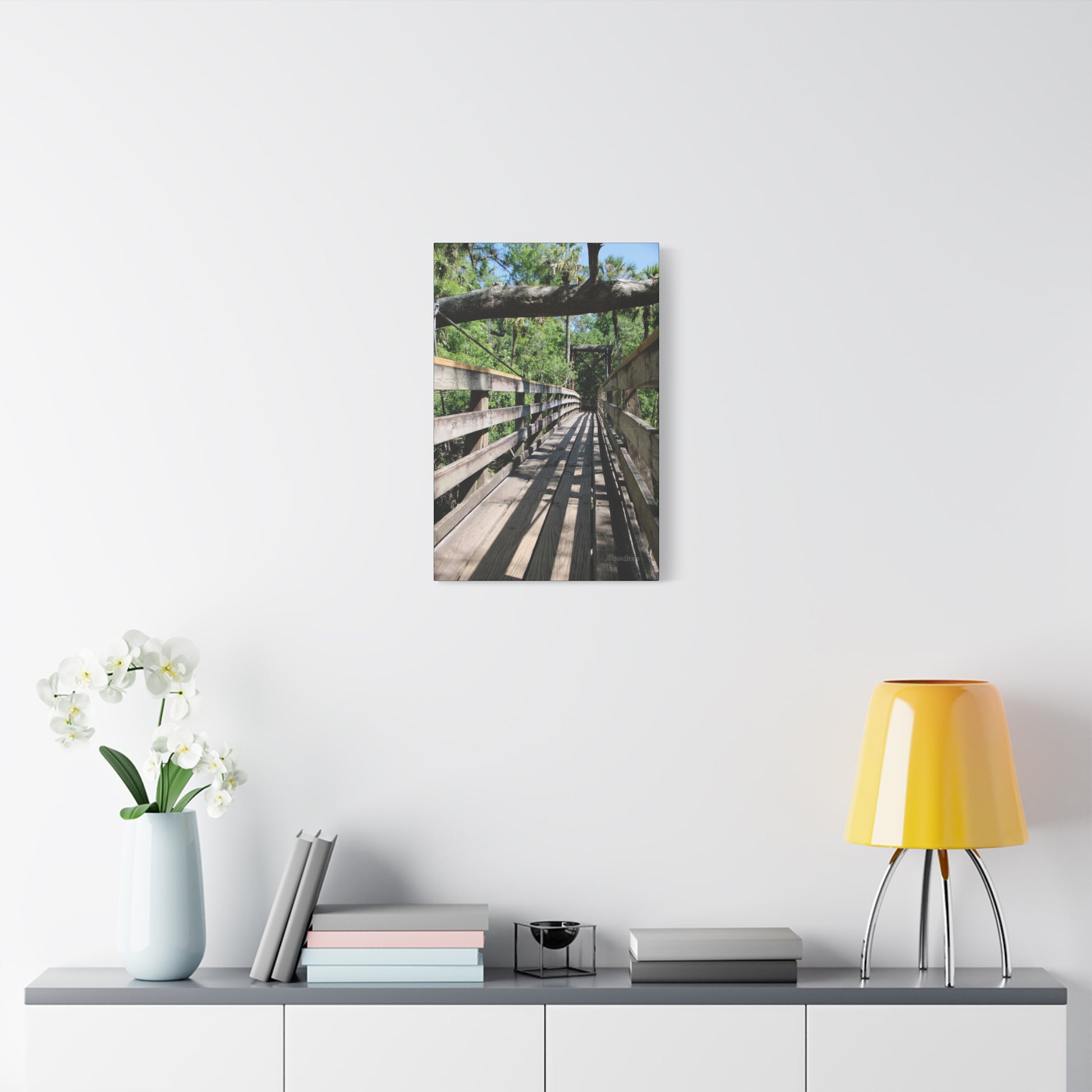 Tranquil bridge nature wall art displayed in a modern living room setting with plants and decor