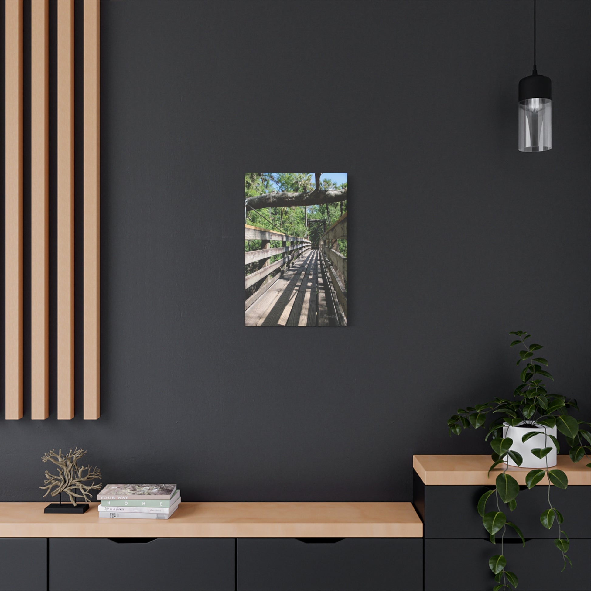 Tranquil bridge nature wall art displayed on a modern wall with decorative plants