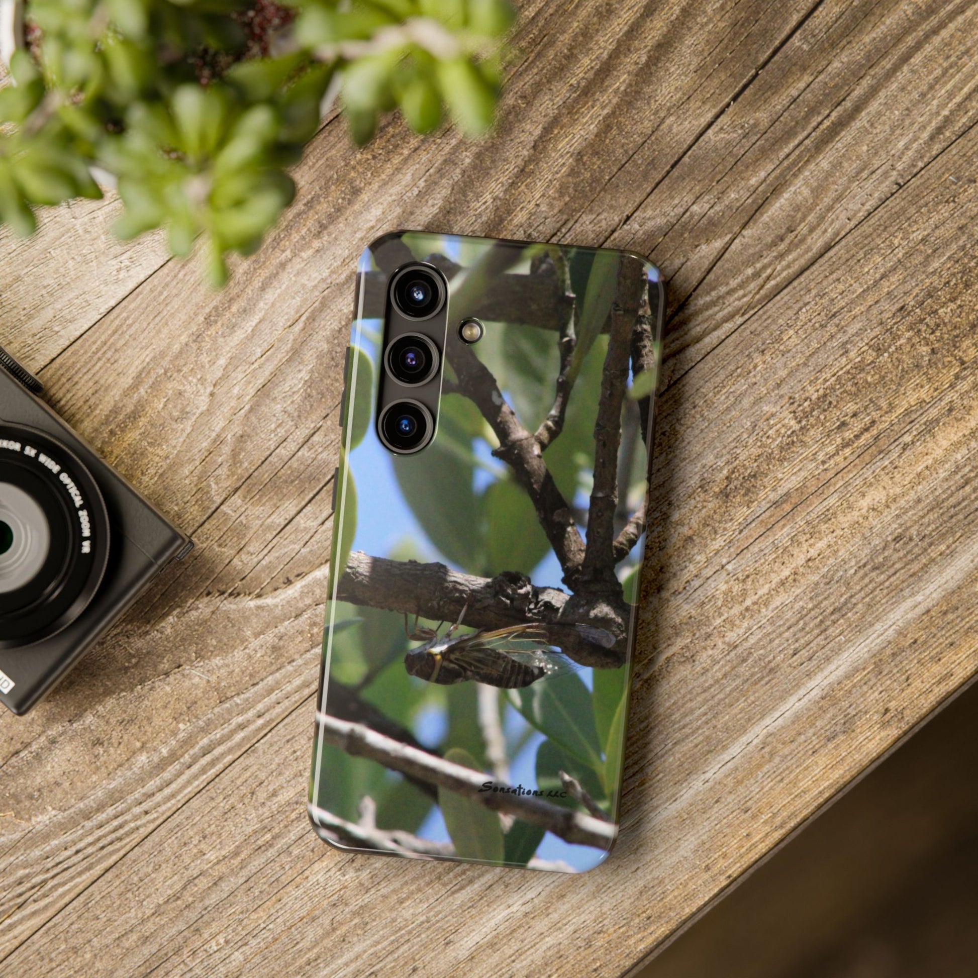 Rugged cicada phone case featuring a vibrant insect design on a durable surface